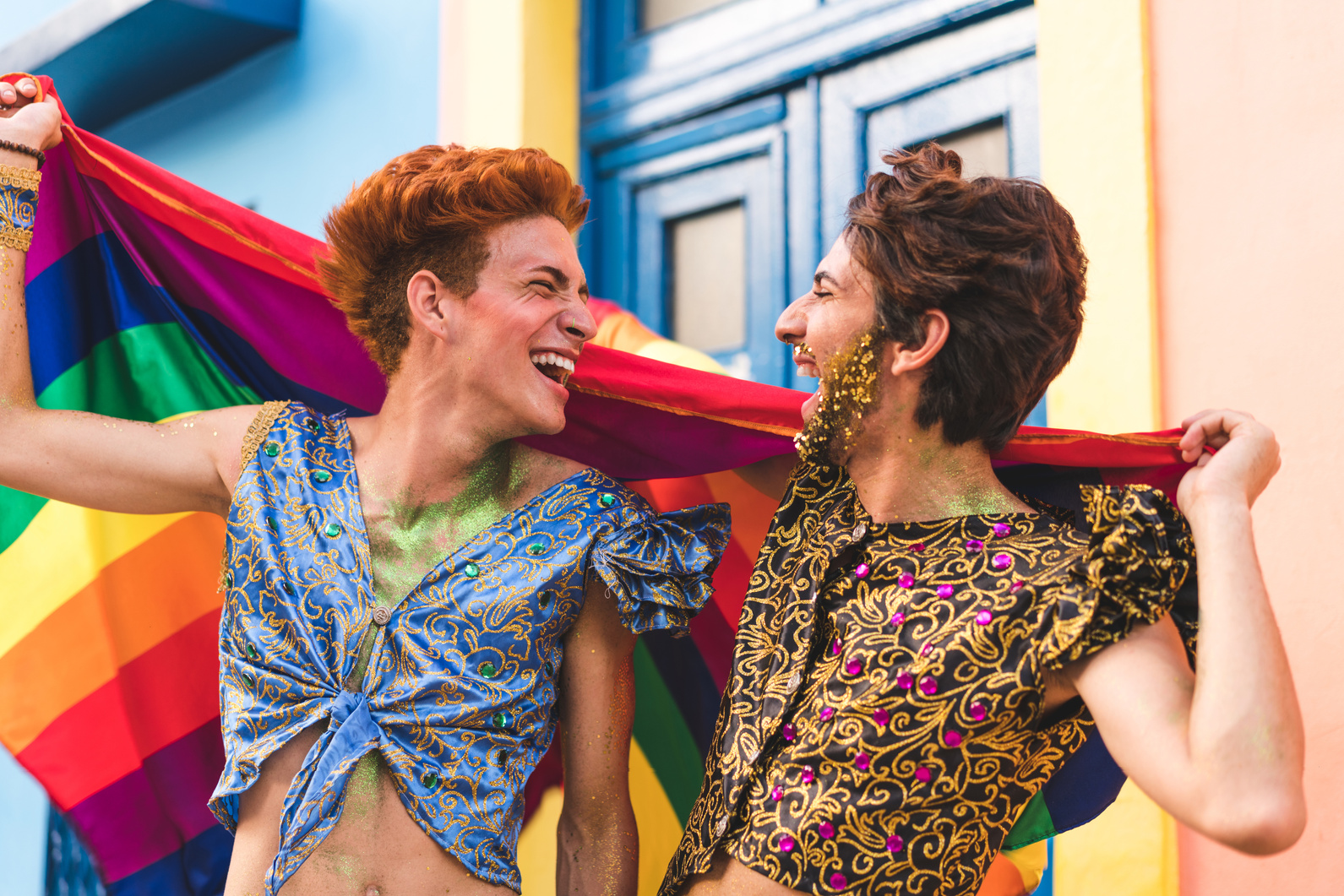 Gay Couple Holding Rainbow Flag at a Pride Parade